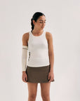 Model wearing Cuera Oncourt Slim Tank Top in Off White, close-up detail on model