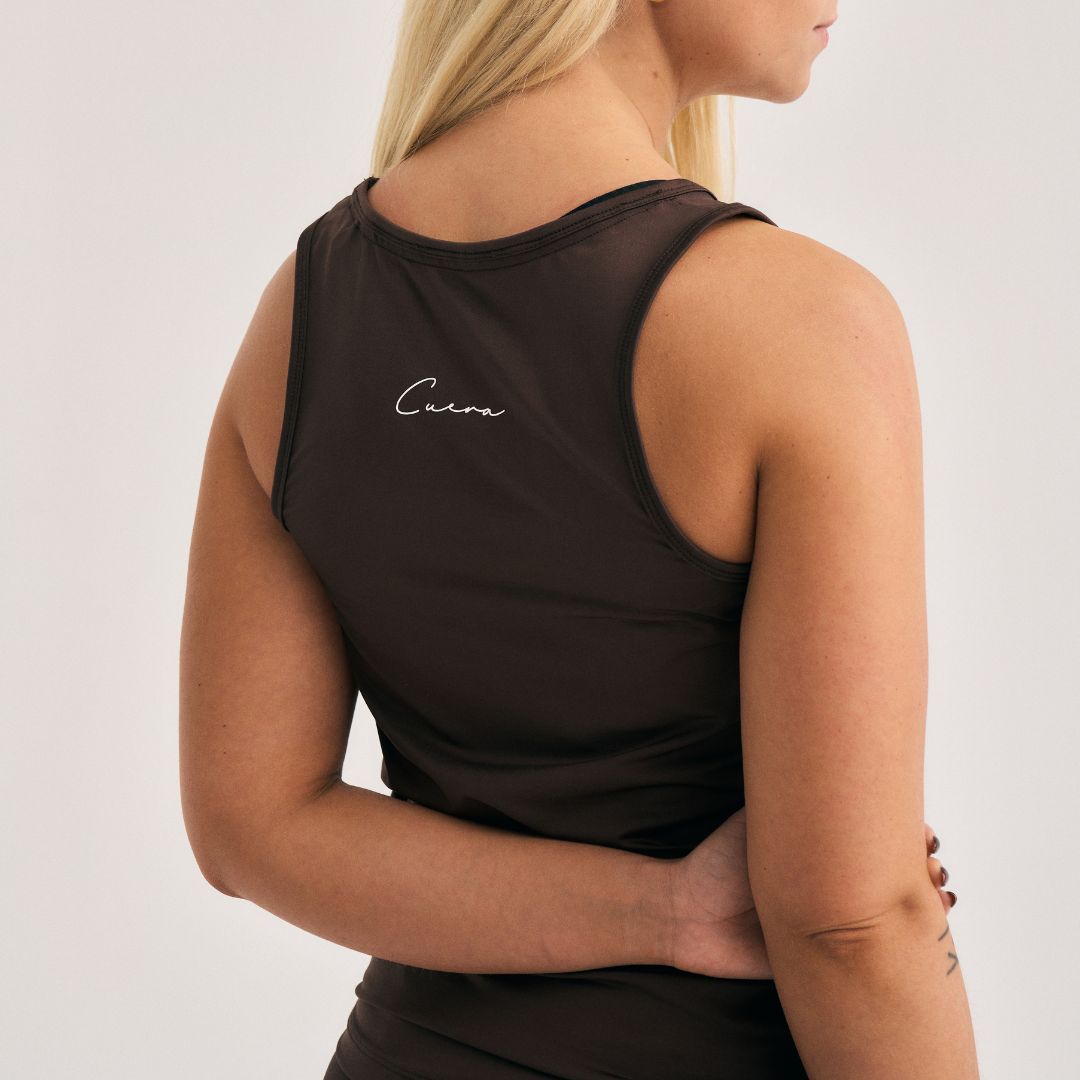 Model wearing Cuera Oncourt Slim Tank Top & Skirt 2-in-1 in Dark Brown Bundle, back studio view