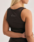 Model wearing Cuera Oncourt Slim Tank Top & Skirt 2-in-1 in Dark Brown Bundle, back studio view