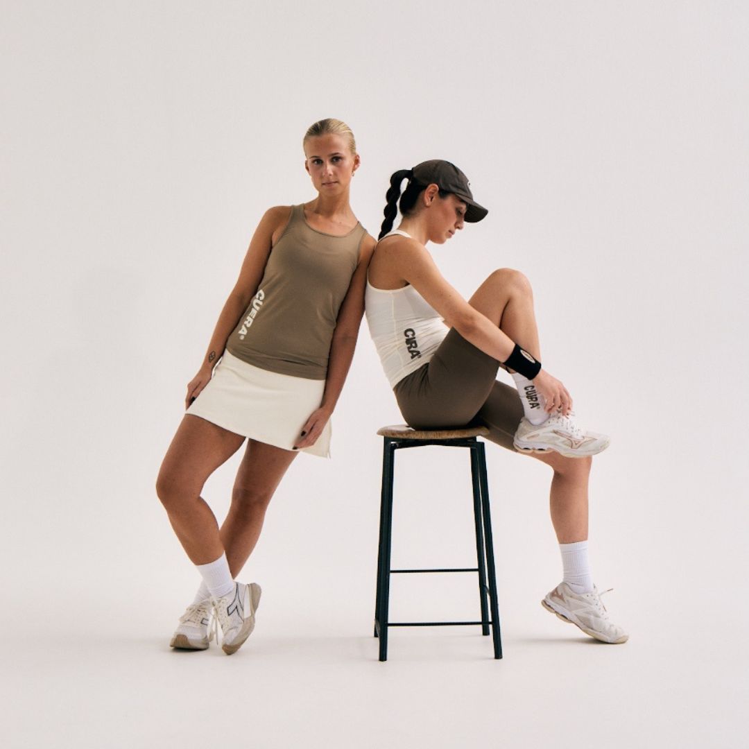 Model wearing Cuera Oncourt Slim Tank Top in Walnut, lifestyle action shot on the padel court