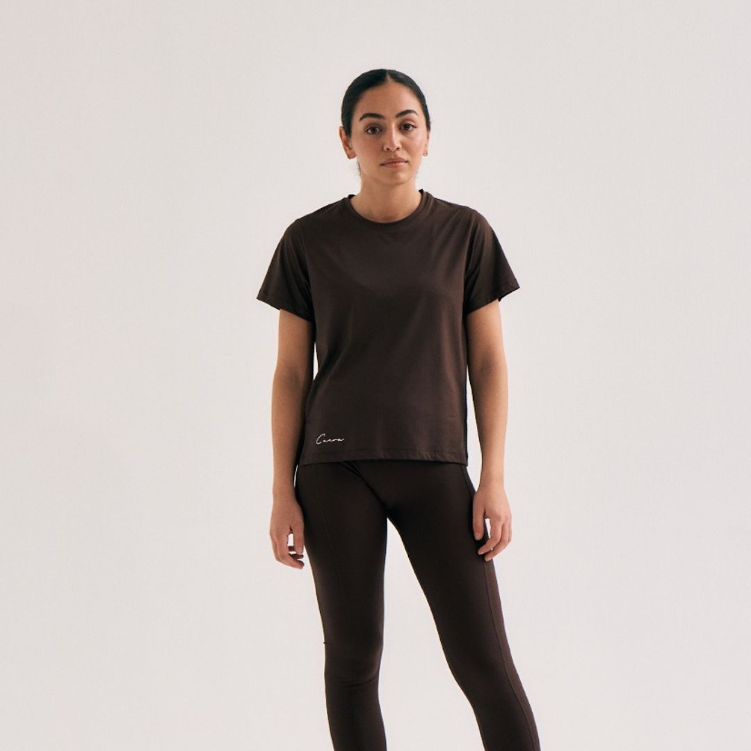 Model wearing Cuera Oncourt Slit Top SS in Dark Brown, front studio view