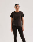 Model wearing Cuera Oncourt Slit Top SS in Dark Brown, front studio view