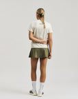 Model wearing Cuera Oncourt Slit Top SS in Off White, back studio view