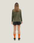 Woman wearing Cuera Women's Active Globe Shorts in Black, back studio view